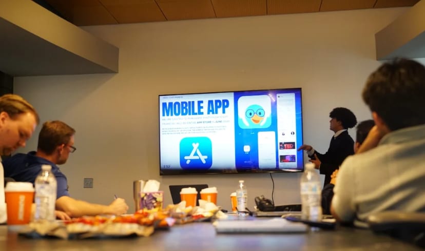 A finalist team pitching a mobile app